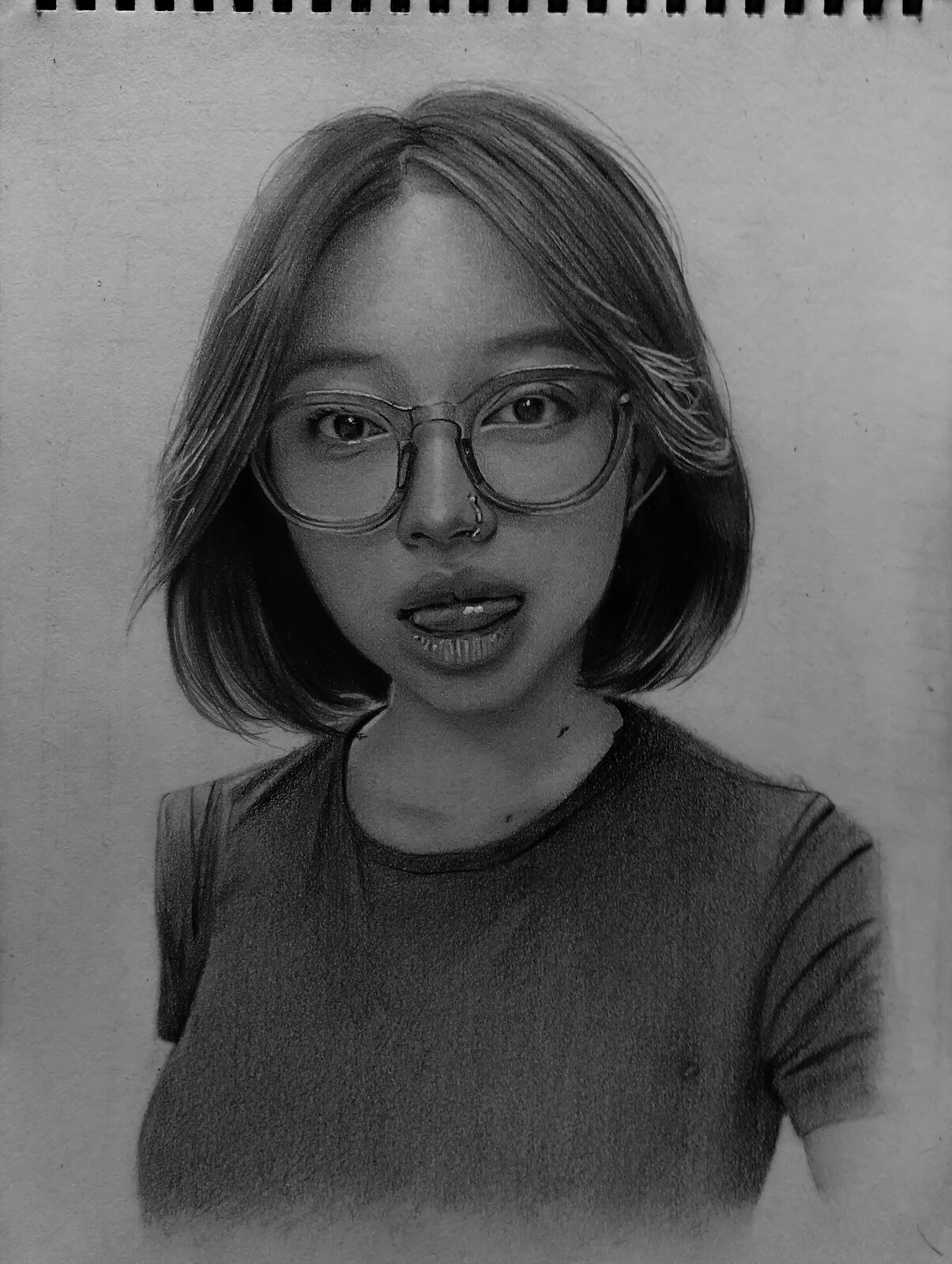 Black and white pencil portrait of a girl wearing glasses